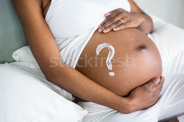 Mulher grávida creme barriga casa cama Foto stock © wavebreak_media