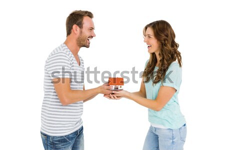 Happy young couple holding model house Stock photo © wavebreak_media