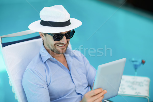Smart man using digital tablet near pool Stock photo © wavebreak_media