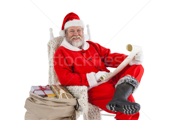 Stock photo: Happy santa claus holding a scroll