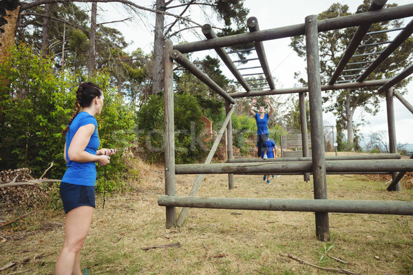 Fit woman climbing monkey bars Stock photo © wavebreak_media