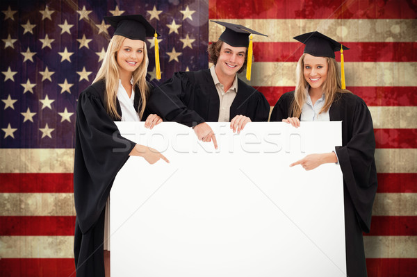 Composite image of three students in graduate robe holding and p Stock photo © wavebreak_media