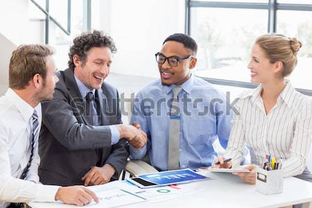 Stock photo: A diverse business group studying a budget plan