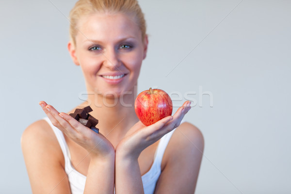 Attractive woman showing chocolate and apple focus on chocolate and apple  Stock photo © wavebreak_media