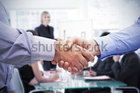 Stock photo: Smiling business people closing a deal
