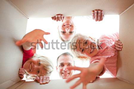 Happy family unpacking boxes in their new house Stock photo © wavebreak_media