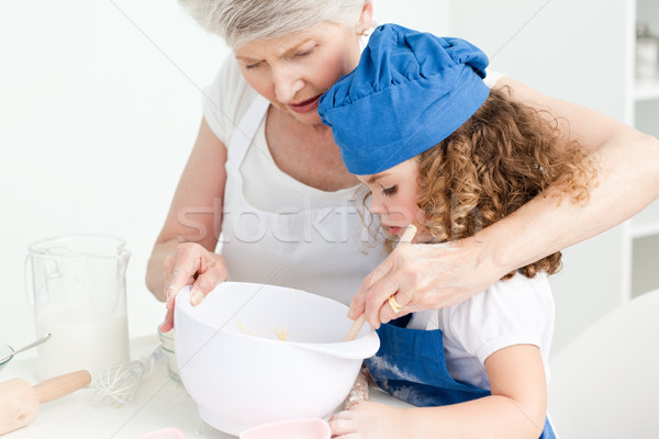 A little girl  baking with her grandmother at home Stock photo © wavebreak_media
