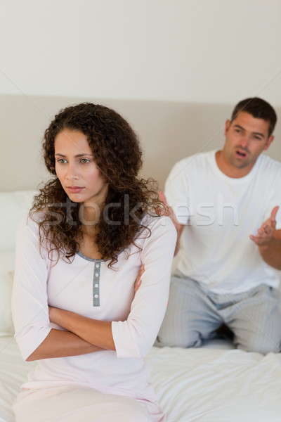 Stock photo: Young couple having a dispute on the bed