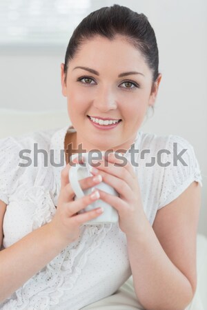 Close up of a woman taking in smell of coffee with her eyes closed in the kitchen Stock photo © wavebreak_media