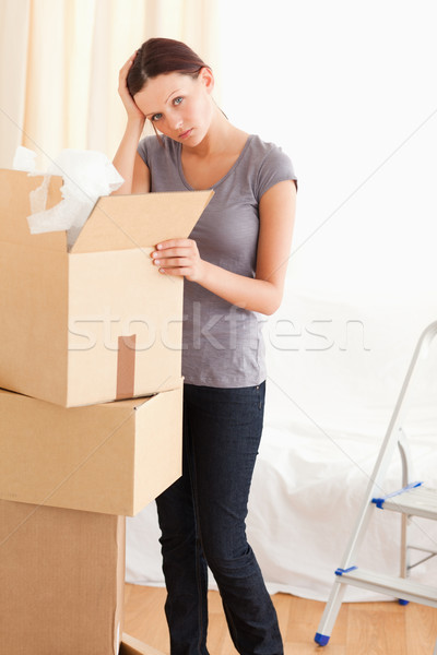 A female is packing a cardboard in the living room Stock photo © wavebreak_media