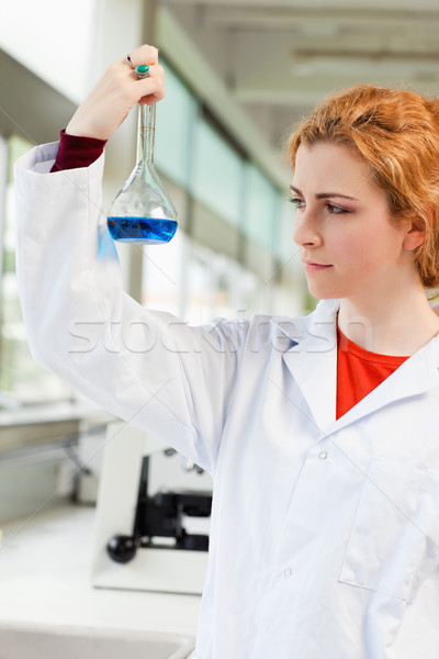Portrait of a cute scientist holding a blue liquid in a laboratory Stock photo © wavebreak_media
