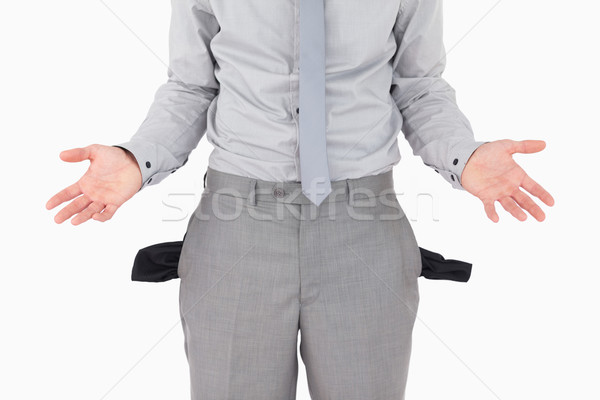Broke businessman with empty pockets against a white background Stock photo © wavebreak_media