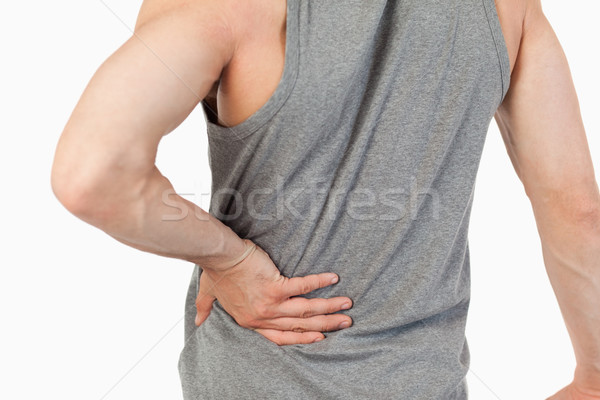 Male hands touching own spine against a white background Stock photo © wavebreak_media