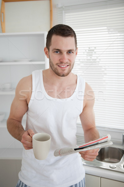 Portrait of a man drinking coffee while reading the news in his kitchen Stock photo © wavebreak_media