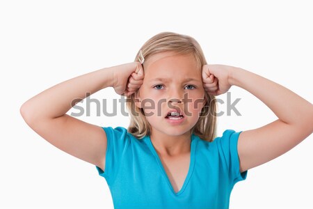 Angry girl with the fists on her face against a white background Stock photo © wavebreak_media