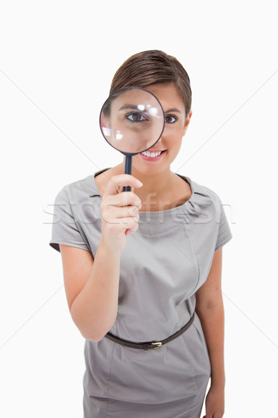 Woman using magnifier against a white background Stock photo © wavebreak_media