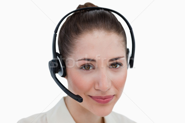 Stock photo: Close up of an operator posing with a headset against a white background