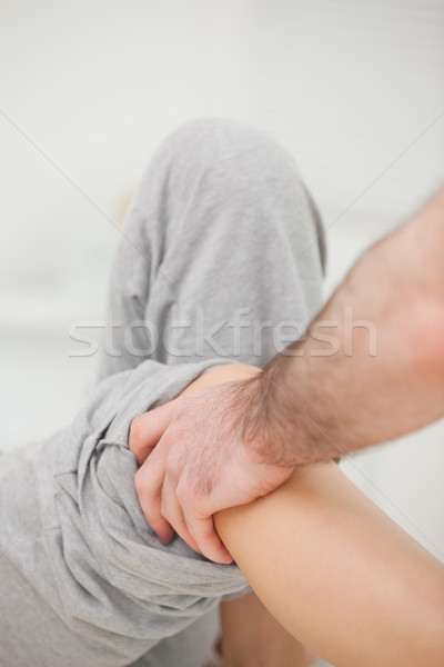 Practitioner looking at the leg of his patient in a room Stock photo © wavebreak_media