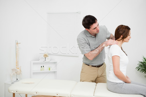 Physiotherapist massaging a brunette woman in a medical room Stock photo © wavebreak_media