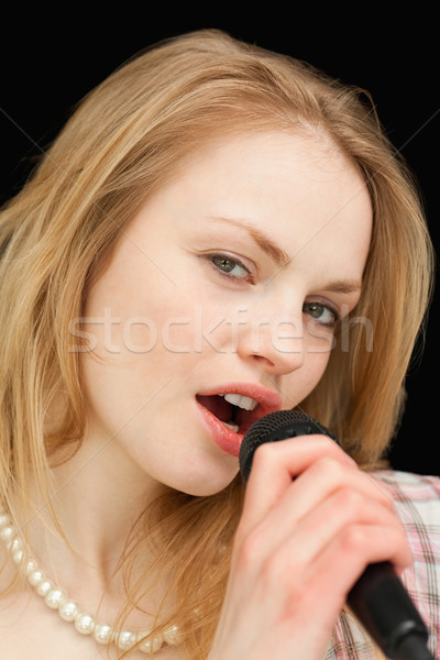 Close up of a woman singing against black background Stock photo © wavebreak_media