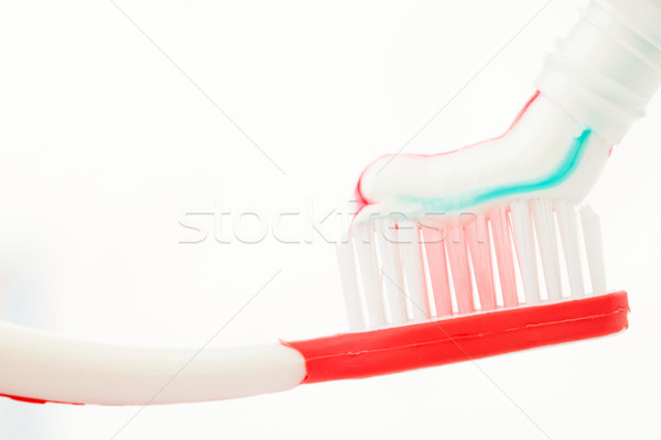 Red toothbrush with multicolour toothpaste Stock photo © wavebreak_media
