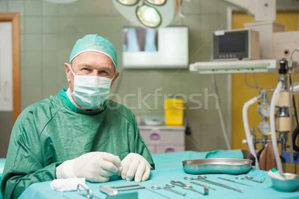 Surgeon sitting next to a table full of a surgical tools in a surgical room Stock photo © wavebreak_media
