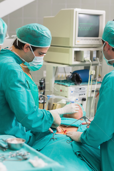 Surgeons using surgical tools in an operating theatre Stock photo © wavebreak_media