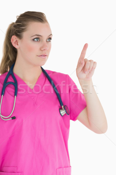 Stock photo: Doctor pointing to something wearing pink scrubs