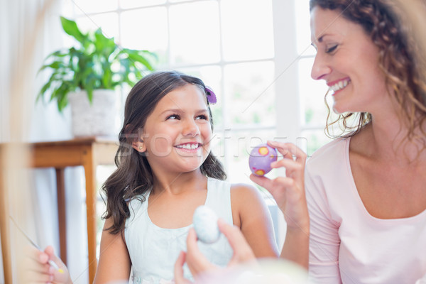 Happy mother and daughter painting easter eggs  Stock photo © wavebreak_media