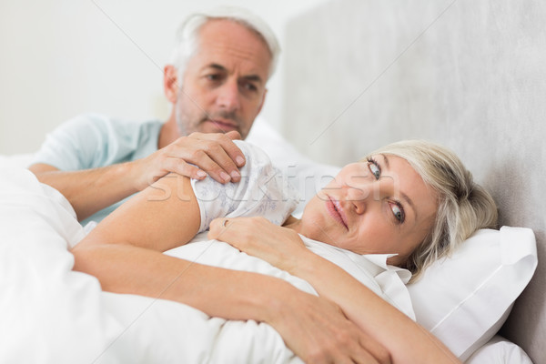 Stock photo: Woman ignoring mature man in bed