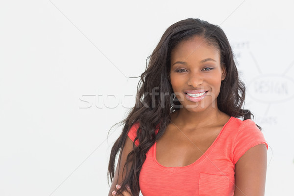 Cheerful designer smiling at camera in front of whiteboard Stock photo © wavebreak_media