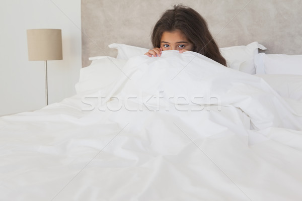 Meisje verbergen gezicht achter vel bed Stockfoto © wavebreak_media