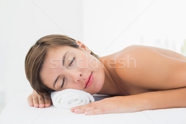 Beautiful woman lying on massage table at spa center Stock photo © wavebreak_media