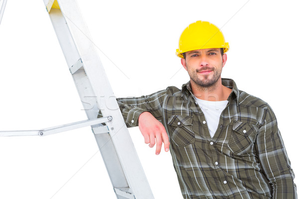 Smiling handyman in overalls leaning on ladder  Stock photo © wavebreak_media