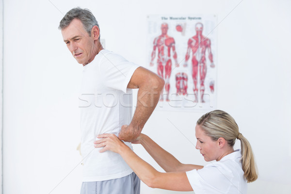 Stock photo: Doctor examining her patient back 