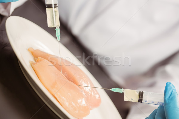 Stock photo: Food scientist injecting raw chicken