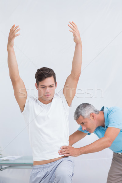 Doctor examining his patient back  Stock photo © wavebreak_media