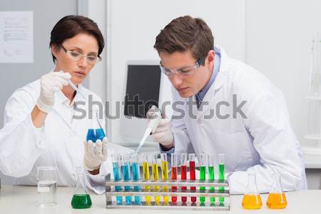 Scientists looking attentively at test tube Stock photo © wavebreak_media