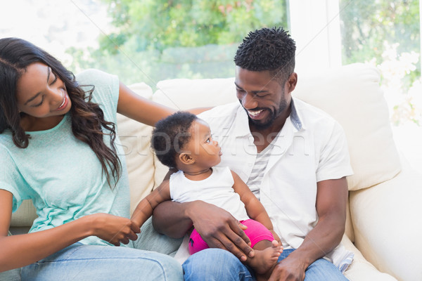Stock photo: Happy couple with their baby girl on couch