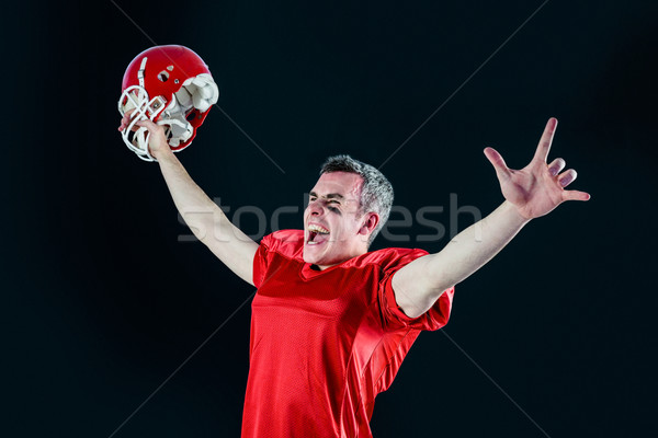 Stock photo: A triumph of an american football player without his helmet 