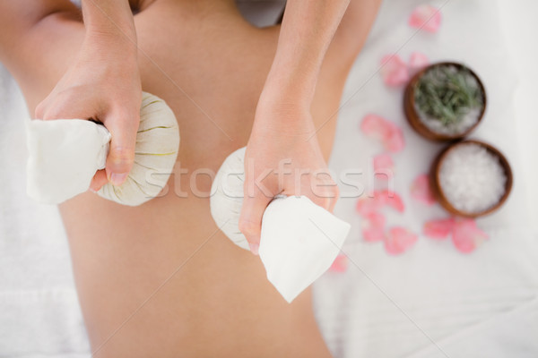Pretty woman enjoying a herbal compress massage Stock photo © wavebreak_media