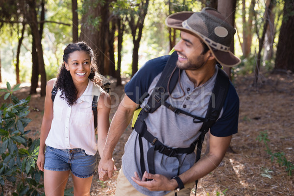 Happy couple holding hands in forest Stock photo © wavebreak_media