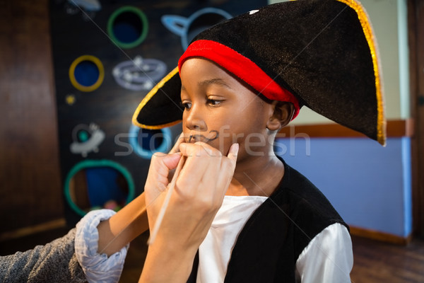 Hand of woman drawing mustache on boy face Stock photo © wavebreak_media