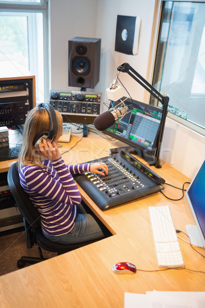 High angle view of female radio host operating sound mixer Stock photo © wavebreak_media