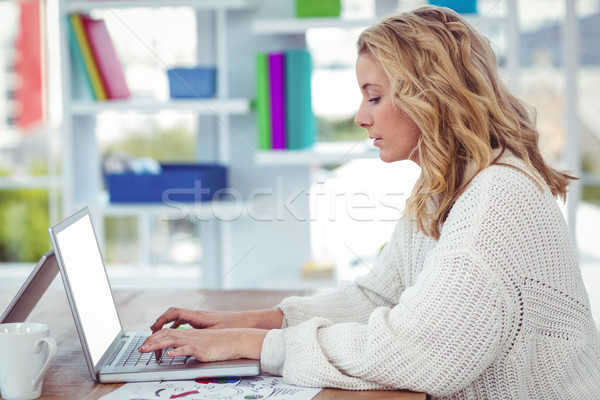 Creative businesswoman working on her laptop Stock photo © wavebreak_media