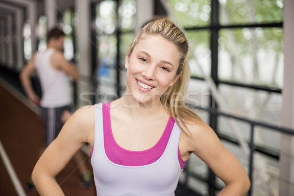 Smiling athletic woman posing with hands on hips  Stock photo © wavebreak_media