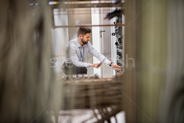 Technician using digital tablet while analyzing server Stock photo © wavebreak_media