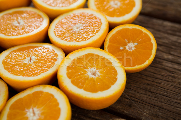Halved oranges on wooden table Stock photo © wavebreak_media