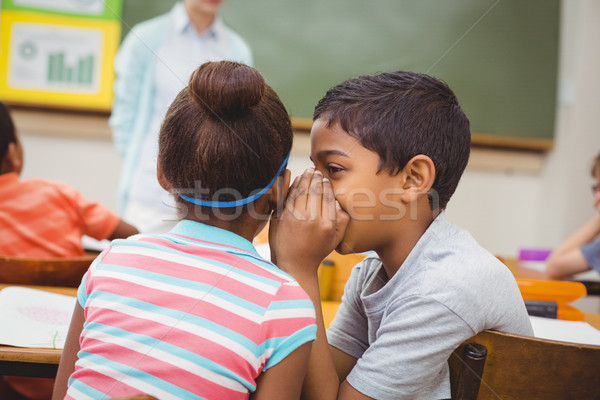 Pupils whispering secrets during class  Stock photo © wavebreak_media