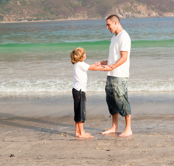 Father and son playing on a beach Stock photo © wavebreak_media